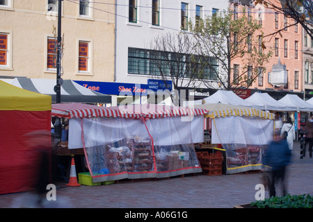 European and Farmer`s market stalls lined up in a row open to local shoppers in Dundee High Street,UK Stock Photo